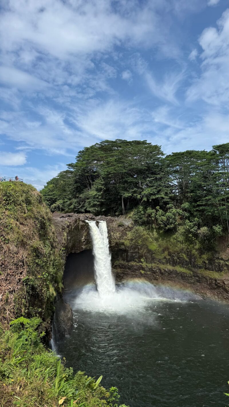 Morning rainbow arcing through the mist as Rainbow Falls plunges into the pool below in Hilo, Big Island