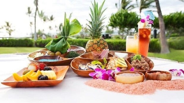 Plate of luau buffet food and a mai tai cocktail at the Sunset Luau, Waikoloa Beach Marriott