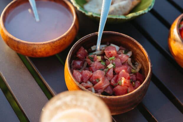Wooden bowl of ʻahi poke with green onion at the Grand Wailea luau dinner