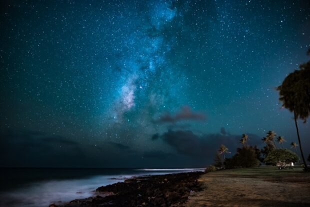 Long exposure shot (notice the elongated star trails) of the Milky Way from a Kauaʻi beach.