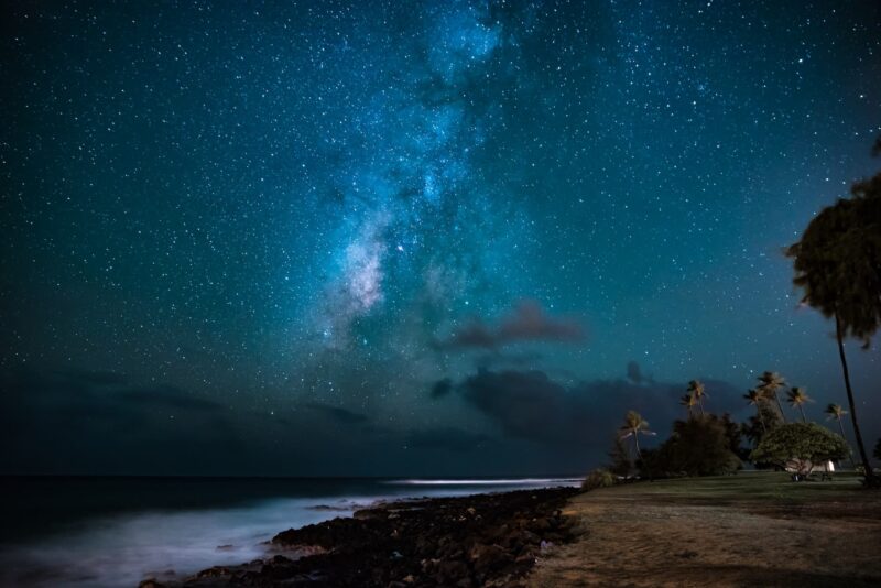 Long exposure shot (notice the elongated star trails) of the Milky Way from a Kauaʻi beach.