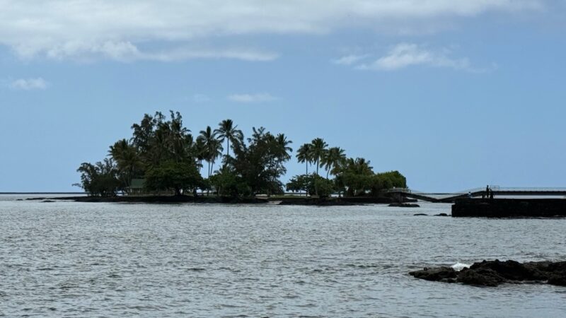 Mokuola, or Coconut Island, in Hilo Bay with its footbridge and coconut palms, seen across the water