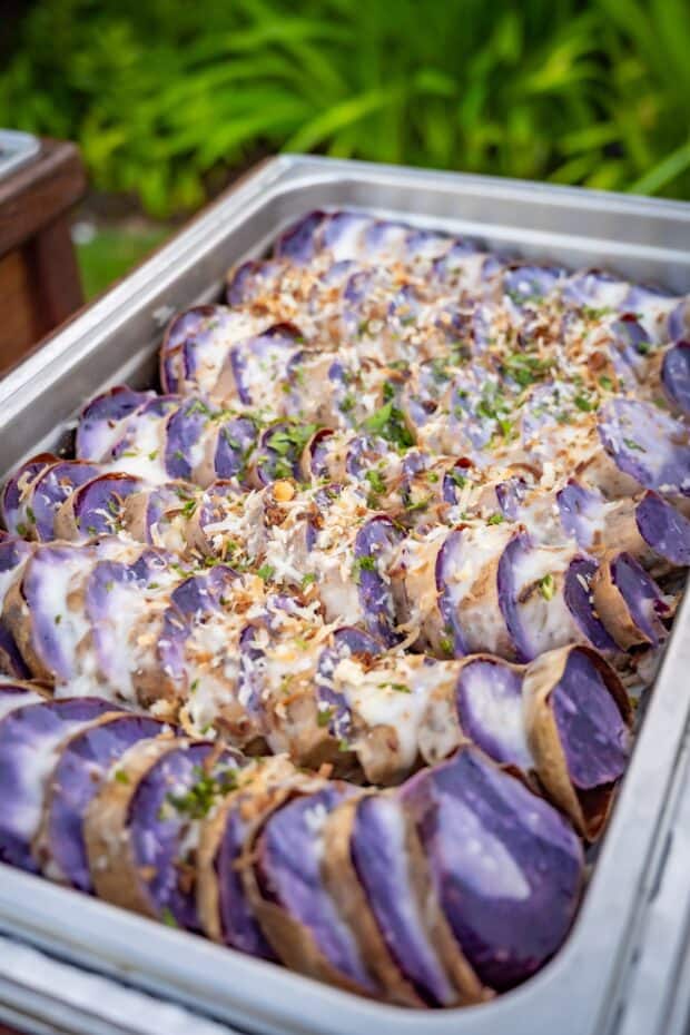 Tray of sliced purple Molokaʻi sweet potatoes with coconut topping at the Grand Hyatt Kauaʻi lūʻau buffet