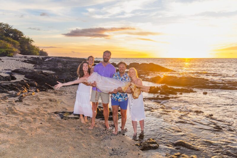 family of 5 at a hawaiian beach during sunset