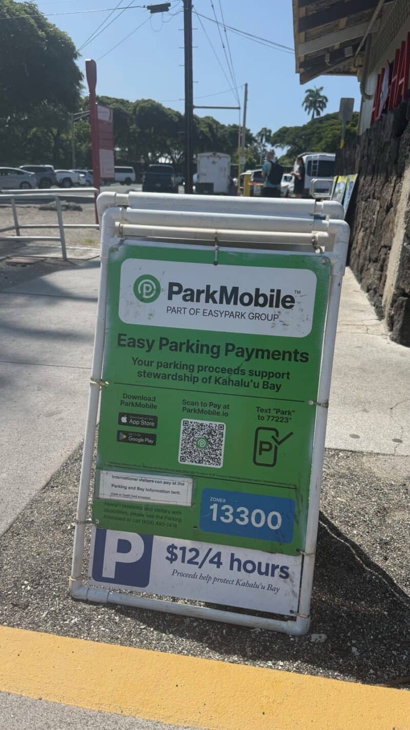 ParkMobile parking sign at Kahaluʻu Beach Park showing zone 13300 and a rate of $12 for 4 hours