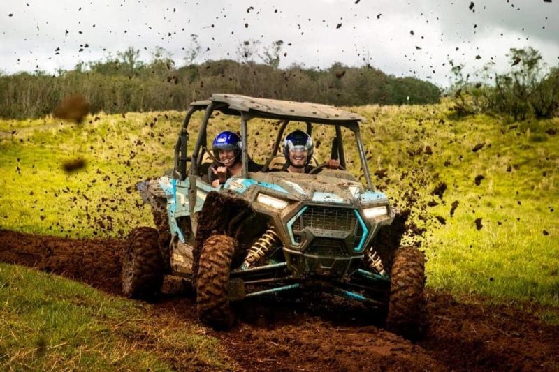 2 people in ATV getting muddy