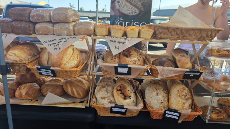Baskets of labeled sourdough loaves from Arise Bakery at the Keauhou Farmers Market