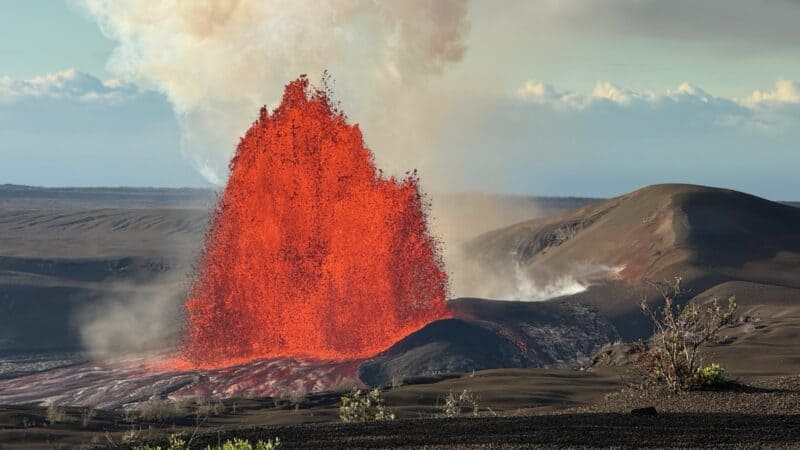 Lava fountain of Kīlauea's episode 55 rising from the north vent in Halemaʻumaʻu, with a steaming cone beside it