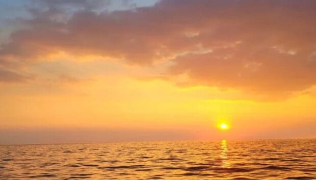 Sunset over open ocean off the Kona coast, seen from the water