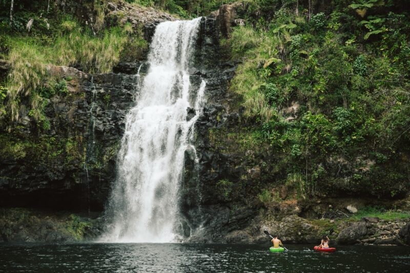 couple kayakking at the kulaniapia falls in Hilo, Hawaii