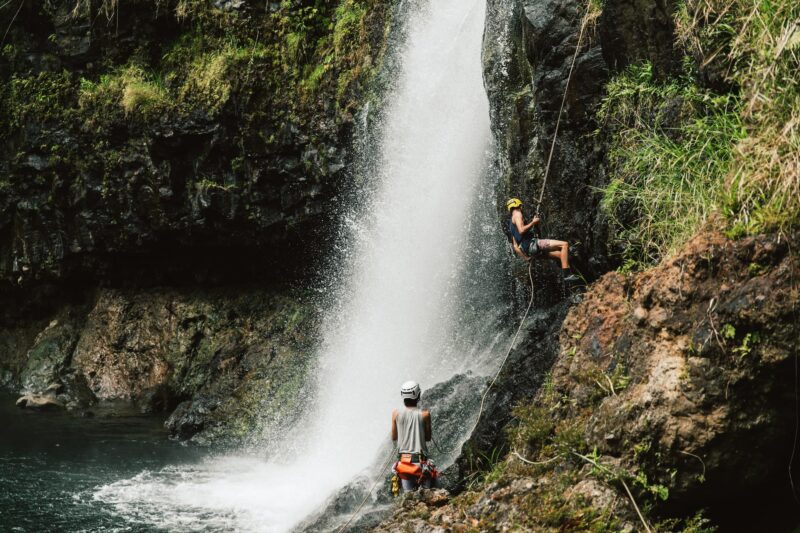 2 people rappelling at the Kulaniapia Falls in Hilo, Hawaii