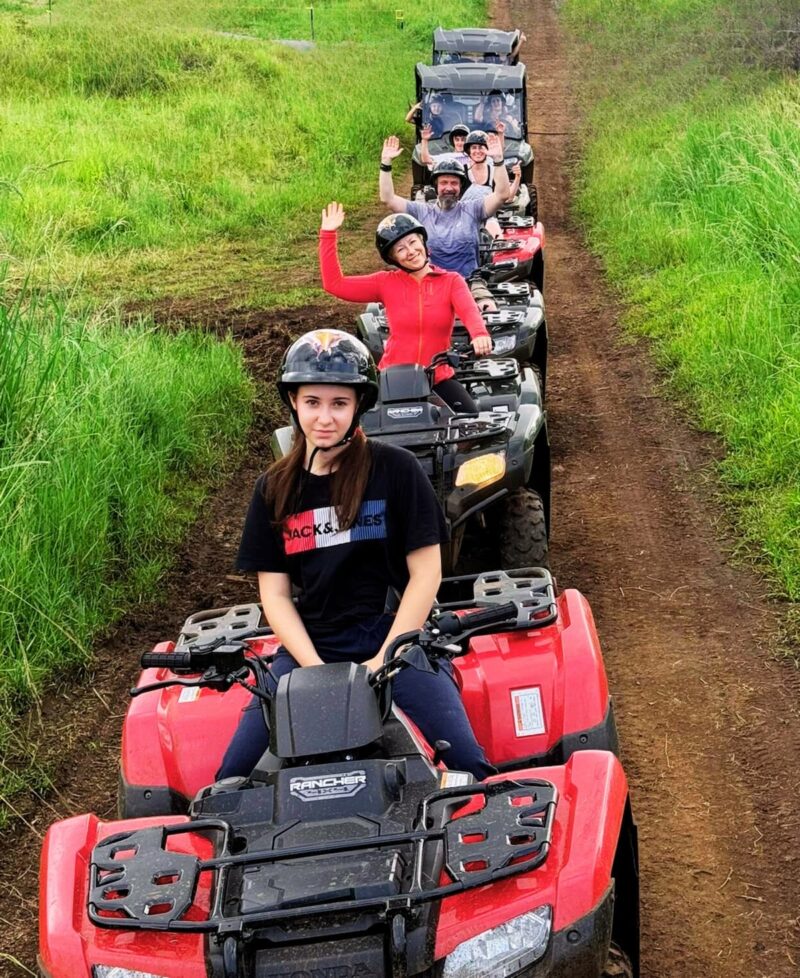 Row of solo ATVs and side-by-side UTVs staged before the guided farm tour at Ohana Ranch, Mountain View Big Island