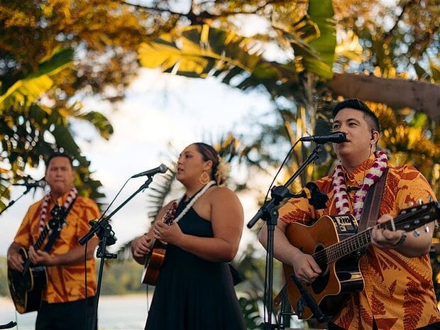 Singer and two guitar players performing live at the Mauna Kea Luau, Mauna Kea Beach Hotel, Big Island Hawaii