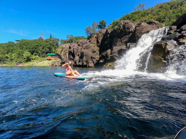 girl on a SUP at the Umauma falls on Big Island