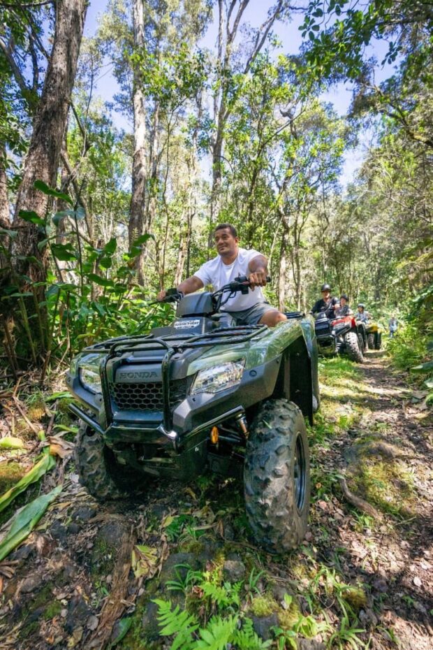 Man riding solo ATV through a forested trail on the Polynesian Cultural ATV tour at Aloha Adventure Farms near Kona