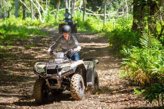 Young rider practicing ATV controls during the supervised beginner orientation at Aloha Adventure Farms in Holualoa