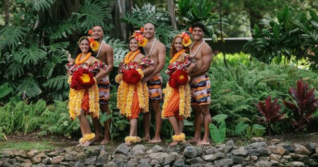 The Kapa Moe Lūʻau cast in leis and hibiscus in the Ritz-Carlton gardens, Kapalua