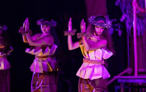 Two hula dancers in stage light at the Tales of the Kapa Moe Lūʻau, Kapalua