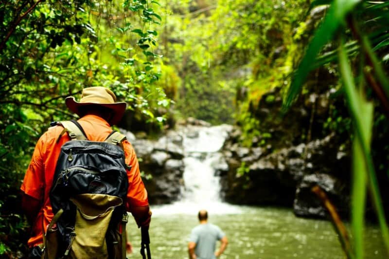 Hiker arriving at Waimano Falls on Oʻahu after a short hike