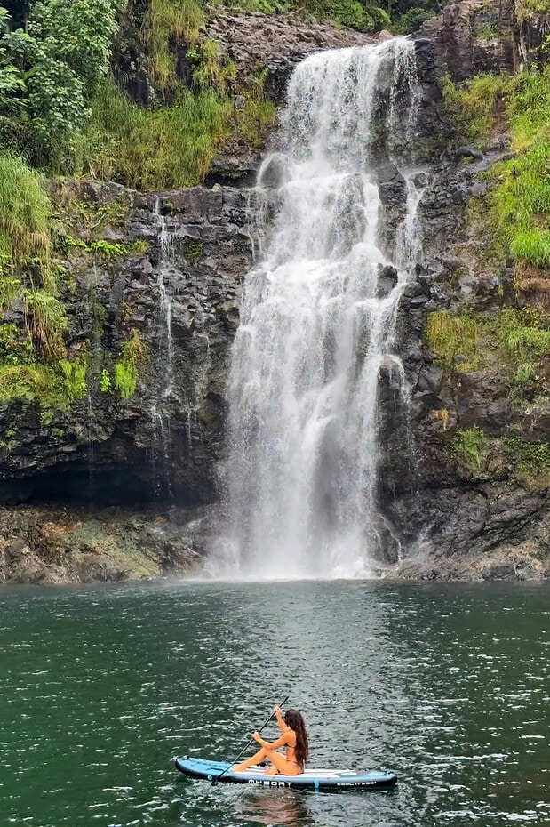Kayaker on the pool fronting the 120-foot Kulaniapia private waterfall