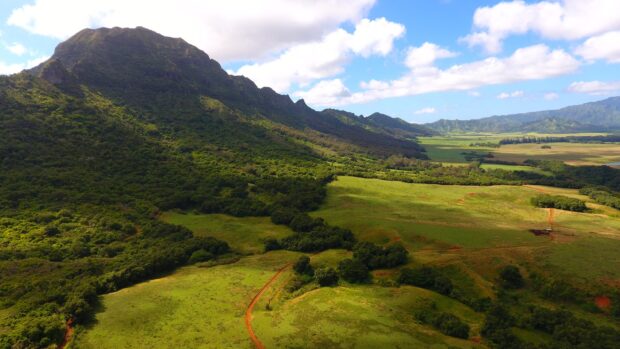 Aerial view of Kipu Ranch pasture and mountains on the Kauaʻi UTV tour route